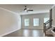 Spacious living room with hardwood floors, ceiling fan, large windows and stairs to a second level at 5477 Blossomwood Sw Trl, Mableton, GA 30126