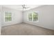 Bright, neutral bedroom with plush carpet, ample natural light, and a ceiling fan at 5497 Blossomwood Sw Trl, Mableton, GA 30126