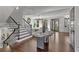 Grand foyer boasting a statement table, a striking staircase, and beautiful hardwood floors, adding a touch of sophistication at 620 Camp Ave, Roswell, GA 30075