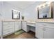 Bright bathroom showcases double sinks with granite countertops and white cabinets for a modern aesthetic at 6808 Greenoak Dr, Douglasville, GA 30135