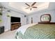 Main bedroom with tray ceilings, a fireplace, a mounted television, carpet, and a view of the ensuite bathroom at 6808 Greenoak Dr, Douglasville, GA 30135