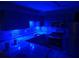 Modern kitchen featuring under-cabinet blue LED accent lighting, new appliances, and tile backsplash at 475 Lakeside Cir, Covington, GA 30016