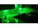 Modern kitchen featuring under-cabinet green LED accent lighting, new appliances, and tile backsplash at 475 Lakeside Cir, Covington, GA 30016
