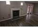 Living room featuring a fireplace, hardwood floors, and natural light from the windows at 475 Lakeside Cir, Covington, GA 30016