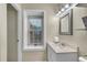 Bathroom featuring a vanity, neutral color, and a window for natural light at 5 Spring Green Pl, Atlanta, GA 30318