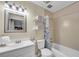 Bright bathroom featuring a shower-tub combo, tile surround, and ample vanity space at 5 Spring Green Pl, Atlanta, GA 30318