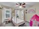 Charming bedroom featuring a canopy bed, ceiling fan, and bright natural light at 5 Spring Green Pl, Atlanta, GA 30318