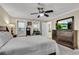 Bedroom with a large bed, and dresser with TV, and windows offering plenty of natural light at 5 Spring Green Pl, Atlanta, GA 30318