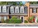 Charming townhome with brick facade, dormer windows, and manicured landscaping at 5 Spring Green Pl, Atlanta, GA 30318