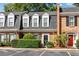 Charming townhome with brick facade, dormer windows, and manicured landscaping at 5 Spring Green Pl, Atlanta, GA 30318