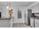 Bright kitchen with stainless steel appliances, tiled flooring, and a door leading to the backyard at 5 Spring Green Pl, Atlanta, GA 30318