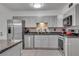Updated kitchen featuring stainless steel appliances, granite countertops, and painted cabinets at 5 Spring Green Pl, Atlanta, GA 30318