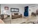 Cozy living room with neutral tones, laminate flooring and view into dining area at 5 Spring Green Pl, Atlanta, GA 30318