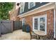 Private patio with brick exterior, grill, and outdoor seating, perfect for entertaining guests at 5 Spring Green Pl, Atlanta, GA 30318