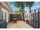 Charming patio area with brick accents, wooden fence, and seating for outdoor entertaining at 5 Spring Green Pl, Atlanta, GA 30318