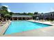 Community pool with lounge chairs and umbrellas at 5 Spring Green Pl, Atlanta, GA 30318