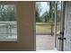 A view of the wooden back porch and deck looking out to a grassy area at 5463 Blossomwood Sw Trl, Mableton, GA 30126