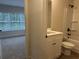 Bathroom featuring a vanity with black fixtures, and view into bedroom with large window at 5463 Blossomwood Sw Trl, Mableton, GA 30126