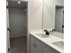 Bathroom featuring double sink vanity with black fixtures and a view into the closet at 5463 Blossomwood Sw Trl, Mableton, GA 30126