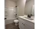 Modern bathroom featuring a shower-tub combo and a vanity with black fixtures at 5463 Blossomwood Sw Trl, Mableton, GA 30126