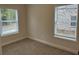 A carpeted bedroom with natural light shining through the windows at 5463 Blossomwood Sw Trl, Mableton, GA 30126