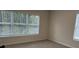 Bright bedroom with large windows, offering ample natural light and a cozy atmosphere for relaxation and rest at 5463 Blossomwood Sw Trl, Mableton, GA 30126