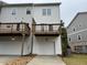 Townhome featuring an attached garage and a deck on the upper level at 5463 Blossomwood Sw Trl, Mableton, GA 30126