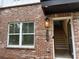 Close up of the front entrance of the townhome with address and brick facade at 5463 Blossomwood Sw Trl, Mableton, GA 30126