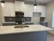 Contemporary kitchen with a gray island and stainless steel appliances at 5463 Blossomwood Sw Trl, Mableton, GA 30126