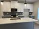 Kitchen featuring a large island, stainless steel appliances and a gray backsplash at 5463 Blossomwood Sw Trl, Mableton, GA 30126