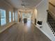 Open-concept living room with modern fireplace and a view into the kitchen and backyard at 5463 Blossomwood Sw Trl, Mableton, GA 30126