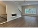 Spacious living room with modern fireplace, hardwood floors, and large windows at 5463 Blossomwood Sw Trl, Mableton, GA 30126