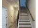 Interior view of the staircase with wooden handrail and gray flooring at 5463 Blossomwood Sw Trl, Mableton, GA 30126