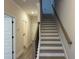 Bright staircase with hardwood treads and a modern handrail design at 5463 Blossomwood Sw Trl, Mableton, GA 30126