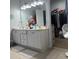 Bathroom featuring double sinks, a large mirror, and a walk-in closet at 1507 Smithfield Dr, Mcdonough, GA 30252