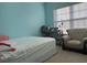 Bright bedroom featuring a single bed, chair, and an expansive window at 1507 Smithfield Dr, Mcdonough, GA 30252