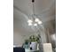 Charming dining room with a decorative chandelier and modern glass table at 1507 Smithfield Dr, Mcdonough, GA 30252