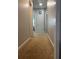 Inviting hallway featuring neutral paint and carpet at 1507 Smithfield Dr, Mcdonough, GA 30252