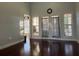 Bright living room with hardwood floors, french doors, and vaulted ceilings at 1507 Smithfield Dr, Mcdonough, GA 30252