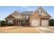 Charming two-story home featuring a stone facade, brick accents, and an attached two-car garage at 108 Long Leaf Way, Canton, GA 30114