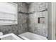 Bathroom with a tub and shower featuring tile and a window at 1472 Norman Berry Dr, Atlanta, GA 30344