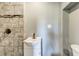 Bathroom featuring tiled shower with bronze fixtures and single sink vanity at 1472 Norman Berry Dr, Atlanta, GA 30344