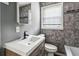 Modern bathroom with stone tile, updated vanity, and contemporary fixtures at 1472 Norman Berry Dr, Atlanta, GA 30344