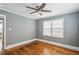 Bedroom featuring hardwood floors, a ceiling fan, and a window providing natural light at 1472 Norman Berry Dr, Atlanta, GA 30344