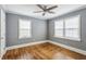 Bright bedroom with hardwood floors, neutral walls, and natural light from two windows at 1472 Norman Berry Dr, Atlanta, GA 30344