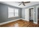Bedroom featuring hardwood floors, a ceiling fan, and a window providing natural light at 1472 Norman Berry Dr, Atlanta, GA 30344