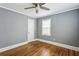 Bedroom with hardwood floors, ceiling fan, and natural light at 1472 Norman Berry Dr, Atlanta, GA 30344