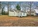 The backyard of the house with small porch and many trees surrounding it at 1472 Norman Berry Dr, Atlanta, GA 30344