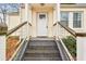 Inviting front porch with classic railings and steps, providing a welcoming entrance at 1472 Norman Berry Dr, Atlanta, GA 30344