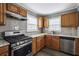 Updated kitchen features stainless steel appliances, wood cabinets and sleek countertops at 1472 Norman Berry Dr, Atlanta, GA 30344